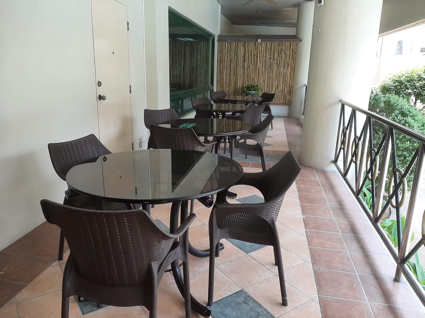 Shaded common area seating beside the pool deck at Palm Towers Makati